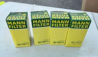 Front view of four boxed MANN-FILTER HU 719/7x oil filters