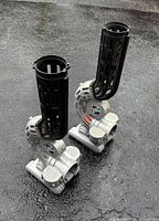 Two NHL puck/ball launchers standing side by side on pavement