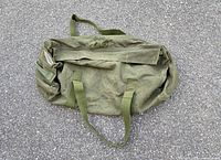 Full view of duffel showing handles, shoulder strap and general wear