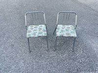 Front view of both chrome chairs on pavement