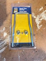 Front view of packaged Power Fist U-bolt spare tire carrier and nuts