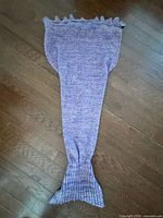 Full view of mermaid tail blanket laid flat
