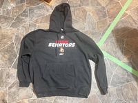 Full view of black Ottawa Senators Reebok hoodie laid flat