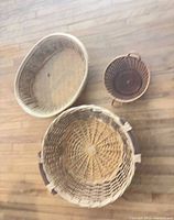 Three baskets laid out to show relative sizes and shapes