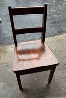 front view of chair showing ladder back, seat and finish