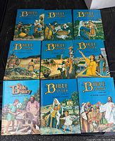 All eight hardcover volumes laid out, showing front covers