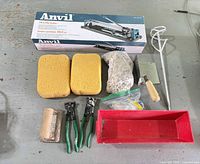Group shot showing all items including boxed tile cutter, sponges, nippers, mixing paddle, spacers, trowel and tray
