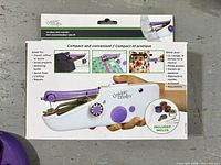 Front of boxed Unique Creativ cordless mini mender sewing machine