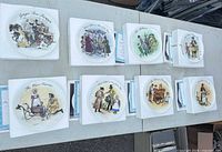 Set of eight Wedgwood Street Sellers plates with boxes and certificates displayed on table