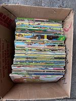 Box containing stacked Wee Wisdom magazines viewed from above