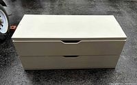 Front view of white two-drawer cabinet showing design and condition