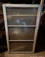 Front view of entire window sash showing three panes and overall condition