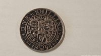 Reverse of 1895 one shilling showing crowned shields and date