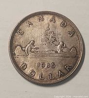 Reverse of 1936 Canada silver dollar showing Voyageur design