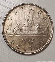 reverse side showing canoe voyageurs and 1937 date