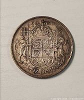 Reverse showing Canadian coat of arms and date