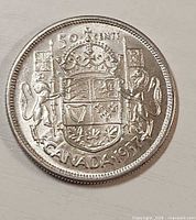 Reverse of 1957 Canadian 50-cent coin showing Canadian Coat of Arms and denomination