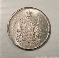 Reverse of 1964 Canadian 50-cent coin displaying coat of arms