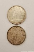 Both coin reverses showing Bluenose schooner and 10 CENTS legend