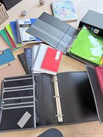 Overview of binders, notebooks, folders spread on floor