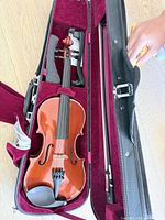 Violin inside open case showing bow and interior