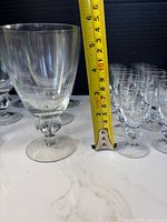 Measuring largest goblet against tape showing height
