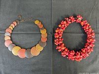 Both necklaces laid out to show overall design
