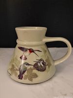 Full view of ceramic mug showing hummingbird design and shape