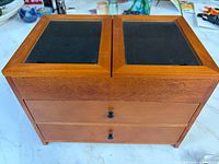 front angled view showing twin top lids and drawer pulls