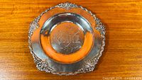 Full view of silver plated cake plate on wooden surface
