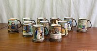 Group shot of ten Charles Dickens mugs showing variety of scenes