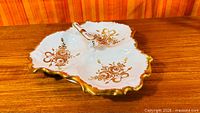 Top view showing three sections, gold floral design, scalloped edge