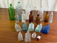 Overview of entire 19-piece bottle collection on tabletop