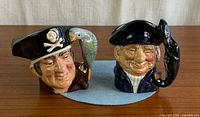 Front view of both Royal Doulton character jugs