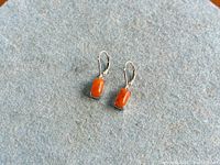 Front view of pair showing coral cabochons and lever-backs