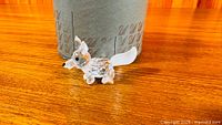 Full view of clear faceted crystal fox figurine in front of box