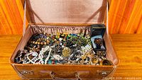 overview of open suitcase filled with jewelry