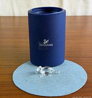 Figurine in front of Swarovski box on felt pad
