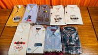 All eight packaged shirts laid out two rows