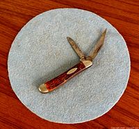 Full view of knife with both blades open on felt background
