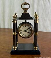 Front view of brass column mantel clock