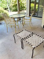 Full patio set showing table, 4 chairs, 2 ottomans