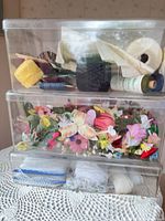 three stacked clear bins with contents visible