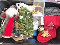 Storage bin showing Santa figurine, mini tree, stocking, ornaments