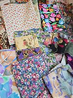 Assorted floral, batik, polka-dot and novelty cotton pieces spread out