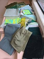 Overhead view of stacked assorted fabric pieces in multiple colors and patterns