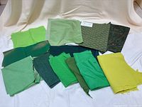 All fabric pieces spread out showing variety of shades and patterns