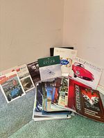 Group shot of mixed magazines and pamphlets stacked against wall