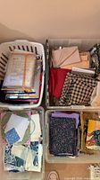 Three storage bins with assorted fabric pieces and pattern packets
