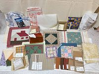 Overview of entire lot showing fat quarters, swatches and quilt blocks